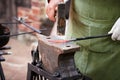 Blacksmith with a hammer in his hands working Royalty Free Stock Photo