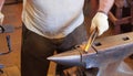 Blacksmith Hammering a Glowing Hot Metal Rod on an Anvil in a Traditional Workshop Royalty Free Stock Photo