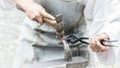 A blacksmith hammering a hot metal piece Royalty Free Stock Photo