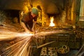 Blacksmith hammering metal in a Forge. UK Royalty Free Stock Photo