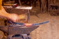 Blacksmith hammering a piece of molten iron Royalty Free Stock Photo