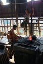 Blacksmith heating iron in a charcoal fire