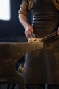 blacksmith holding iron work in forge Royalty Free Stock Photo