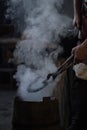 blacksmith holding iron work in forge Royalty Free Stock Photo