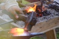 Blacksmith horn outdoors with burning coals, follow focus