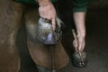 Blacksmith with Horse, Hitting Nail into newly fitted Horses Shoe