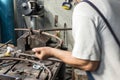 Blacksmith making wrought Iron with industrial bender equipment machine for metal bending. Royalty Free Stock Photo