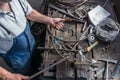 Blacksmith making wrought Iron with industrial bender equipment machine for metal bending. Royalty Free Stock Photo