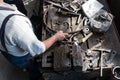 Blacksmith making wrought Iron with industrial bender equipment machine for metal bending. Royalty Free Stock Photo