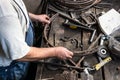 Blacksmith making wrought Iron with industrial bender equipment machine for metal bending. Royalty Free Stock Photo