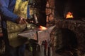 Blacksmith manually forging the molten metal