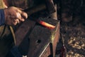 The blacksmith manually forging the molten metal