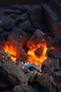 blacksmith performs the forging of hot glowing metal on the anvil