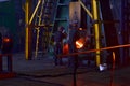 Blacksmith processes the red hot iron under a huge press. Metal forging, stamping under hammer forge at workshop of forge foctory Royalty Free Stock Photo