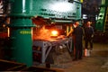 Blacksmith processes the red hot iron under a huge press. Metal forging, stamping under hammer forge at workshop of forge foctory Royalty Free Stock Photo