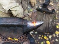 Blacksmith processing red hot iron rod on anvil Royalty Free Stock Photo