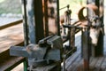 Blacksmith`s clamp. Metal clamping device on an old workbench. Vise desktop