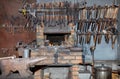 Metal anvil in a blacksmith shop and various tools in blur