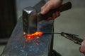 Blacksmith`s hands make detail on the anvil, male work