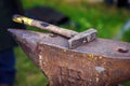 Blacksmith`s workshop. Working metal tools in smithy. Close-up shot of forge consisting of old rusty rugged anvil and hammer,