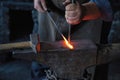 Punching a Hole in White-Hot Iron on an Anvil