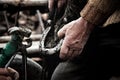 Blacksmith shoeing a horse