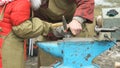 Blacksmith teaching girl how to do smithing