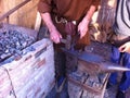 Blacksmith at work on an anvil at a medieval street market