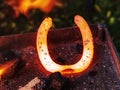 Blacksmith working on the anvil, making a horseshoe