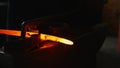 Blacksmith working with hot glowing metal, bending steel in a smithery Royalty Free Stock Photo