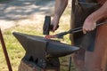 Blacksmith Working Incandescent Iron with Hammer and Anvil