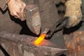 Detail shot of hammer forging hot iron at anvil Royalty Free Stock Photo