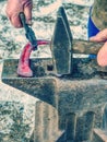 Blacksmith working to finalize horseshoe Royalty Free Stock Photo