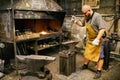 Blacksmith working in workshop Royalty Free Stock Photo