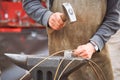 Blacksmith works with an anvil like he used to