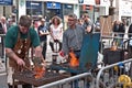 Blacksmiths demonstrate their work.