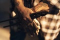 A blacksmiths hands are her greatest tools. an unrecognisable holding a pair of gloves while working at a foundry. Royalty Free Stock Photo