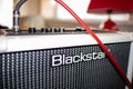 Blackstar amplifier and red guitar cord Royalty Free Stock Photo