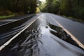 blacktop road, with water running down the surface in sheets