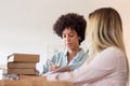 Blackwoman discussing parcel with colleague