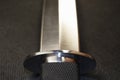 Blade of a large hunting knife close-up isolated