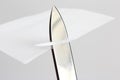 Blade of a sharp knife cut across the white paper Royalty Free Stock Photo