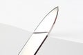 Blade of a sharp knife cut across the white paper Royalty Free Stock Photo