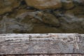 Old wooden board near quiet clear water Royalty Free Stock Photo