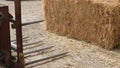 Blades of tractor shovel  in front of the barn with hay bales Royalty Free Stock Photo