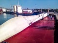 Blades of the wind farm are fixed on the deck of the ship in the port and are ready for transport Royalty Free Stock Photo