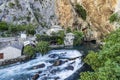 Cascading Buna River spring, Vrelo Buna, with 16th Century Tekke, at Blagaj Village, in Mostar, Bosnia-Harzegovina. Royalty Free Stock Photo