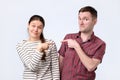 Blaming each other. Beautiful young european couple pointing each othe Royalty Free Stock Photo
