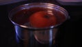 blanch tomato in boiling water closeup