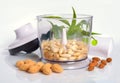 Blanched almonds In a blender with unshelled nuts. On white back